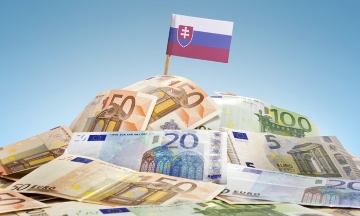The National Flag Of Slovakia Sticking In A Pile Of Mixed European Banknotes