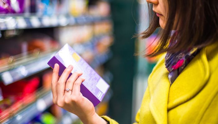 Woman looking at a product in a supermarket