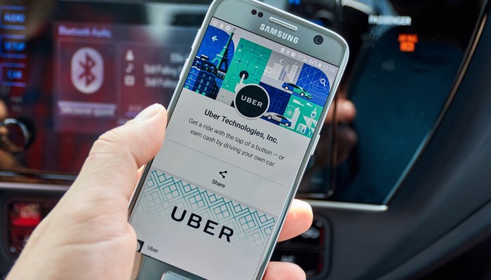 Uber driver using app on their phone