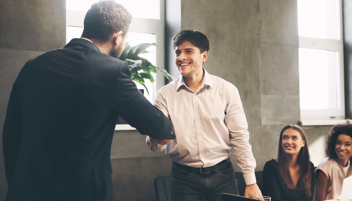 Boss promoting worker showing respect and shaking hands