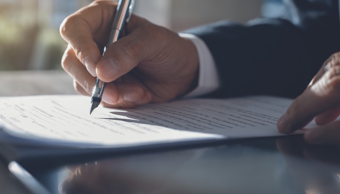 Person signing a legal document