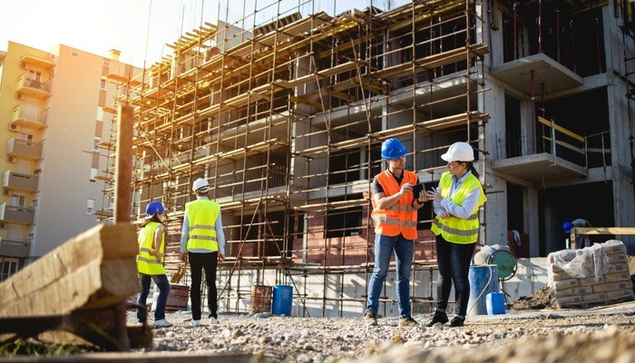 Four construction workers having meeting