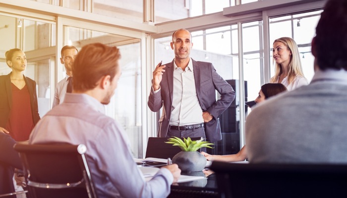 A business leader talking to his team