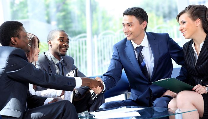 Businesspeople shaking hands at a meeting
