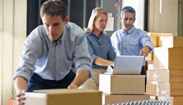 Entrepreneurs checking their orders in their warehouse