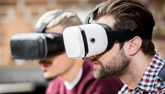 Two men with virtual reality headsets on