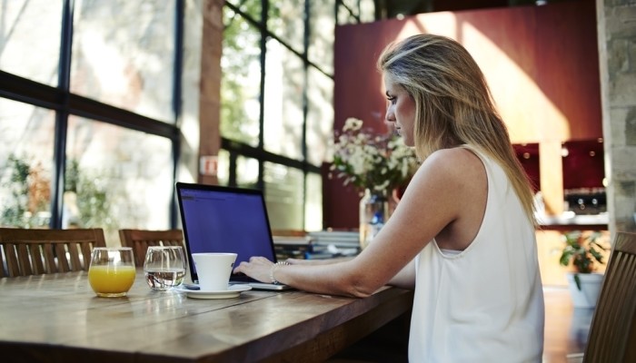 Young Female Freelancer Using Laptop Computer