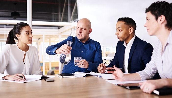 Woman pitching to three venture capitalists