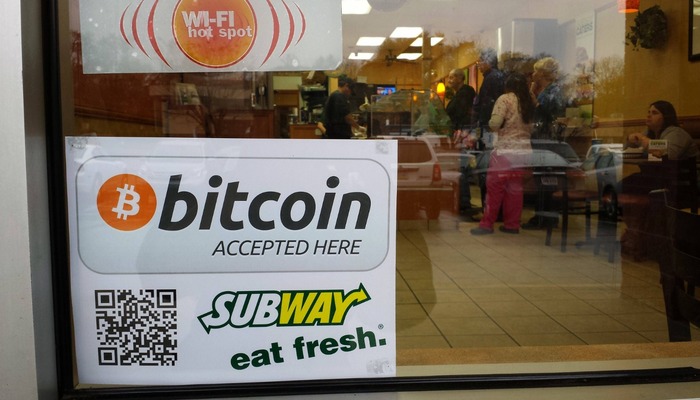 Sign in a Subway window detailing acceptance of bitcoin payments