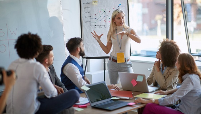 Woman giving presentation to colleagues