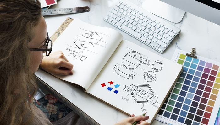 Young woman designing logos