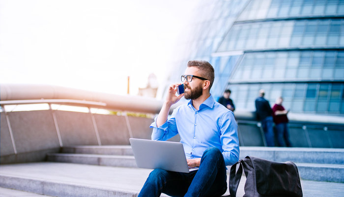 Young businessman sitting outside on stairs